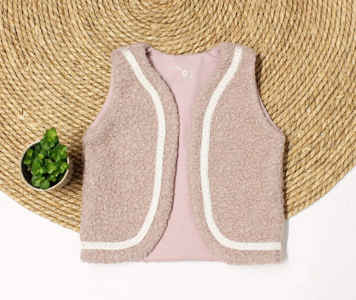 Gilet boucle met sierband